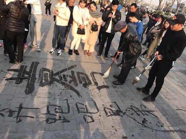 郑恺北京街头炫书法 拿大毛笔在地上写字(图)