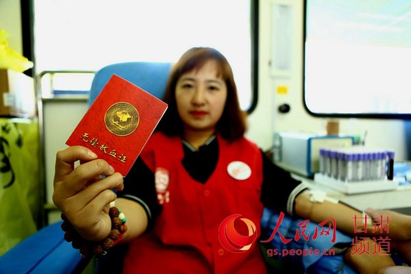 12日，甘肃兰州，多次无偿献血的献血者李小梅向记者展示她的献血证。牟健 摄