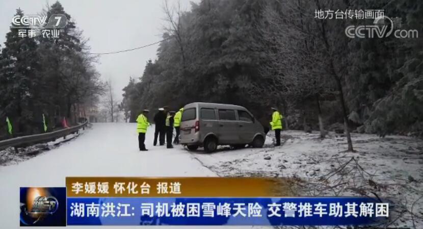 司机被困雪峰天险交警推车助其解困